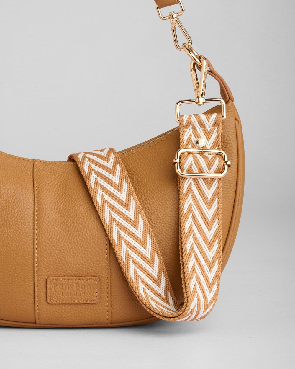 Pom Pom London Sutton Sling Bag in maple tan leather with chevron patterned strap