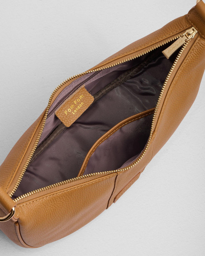 Pom Pom London Sutton Sling Bag in maple brown leather, open view showing interior compartments