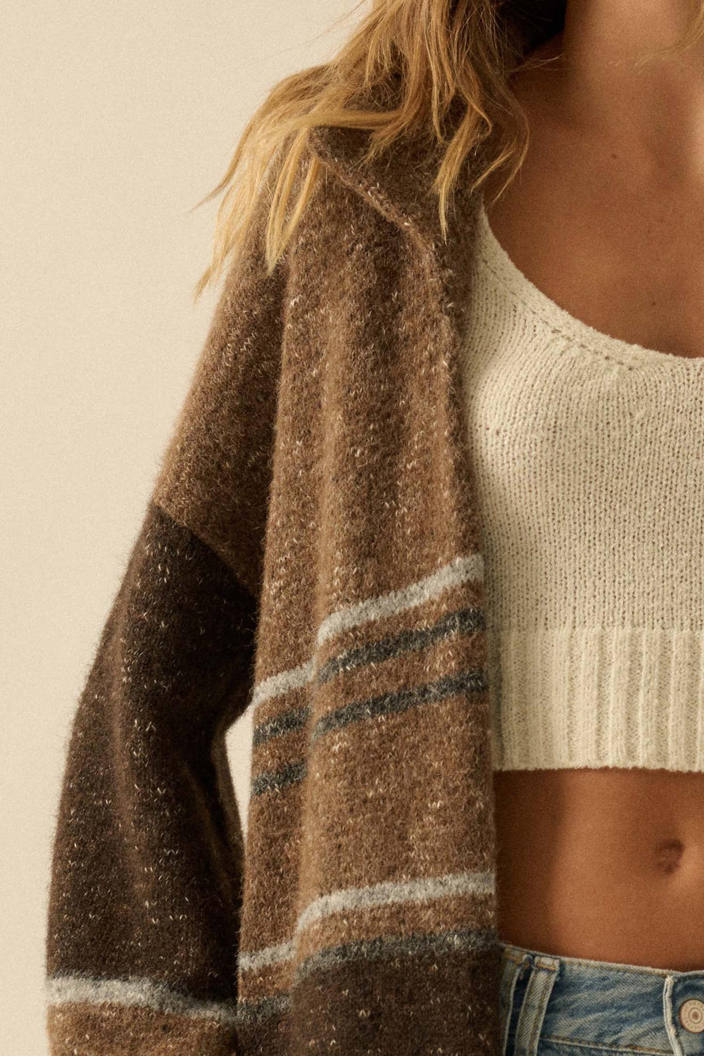 Woman wearing taupe striped confetti duster cardigan over white crop top