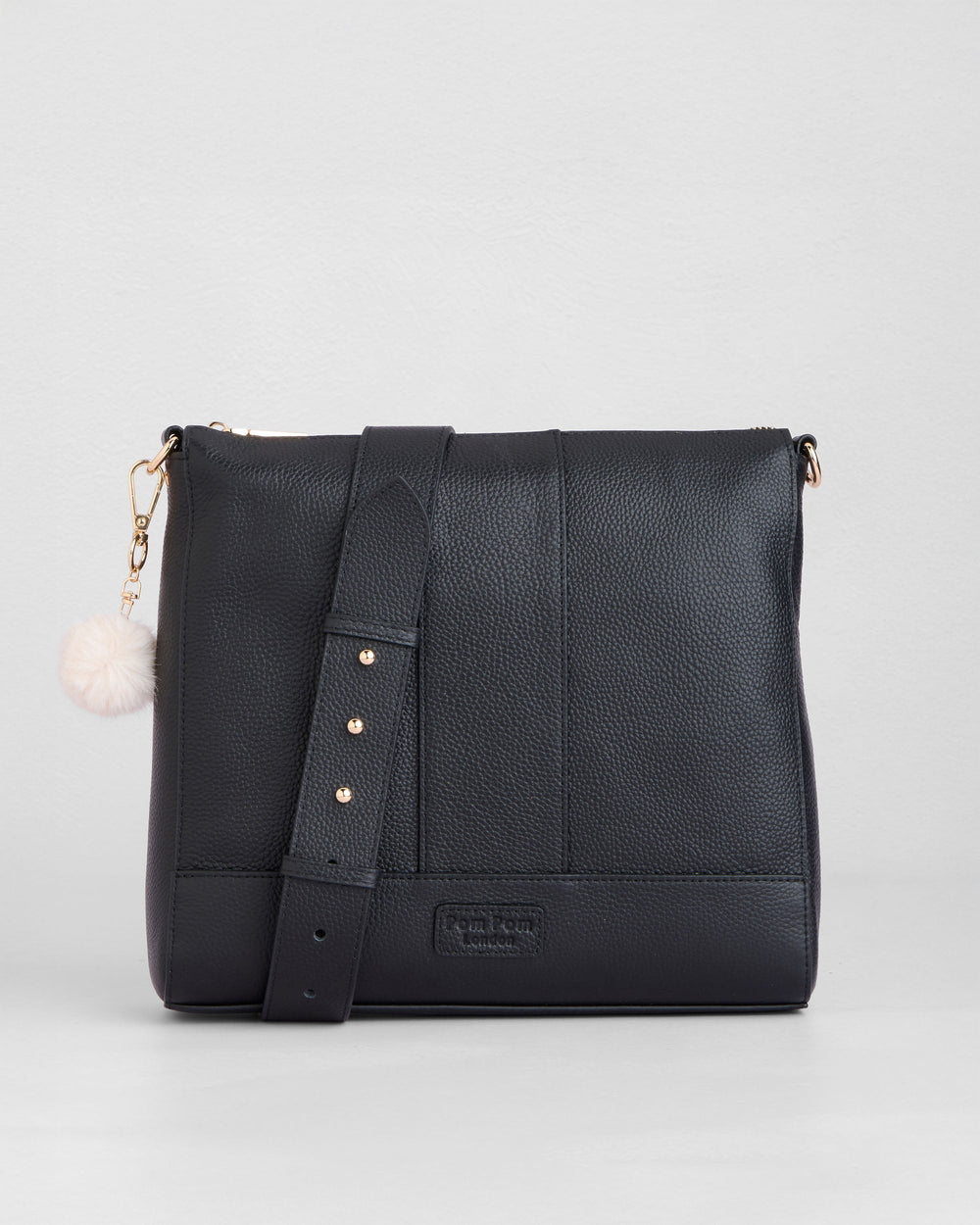 Black leather Westminster crossbody bag with white pom pom charm and gold hardware