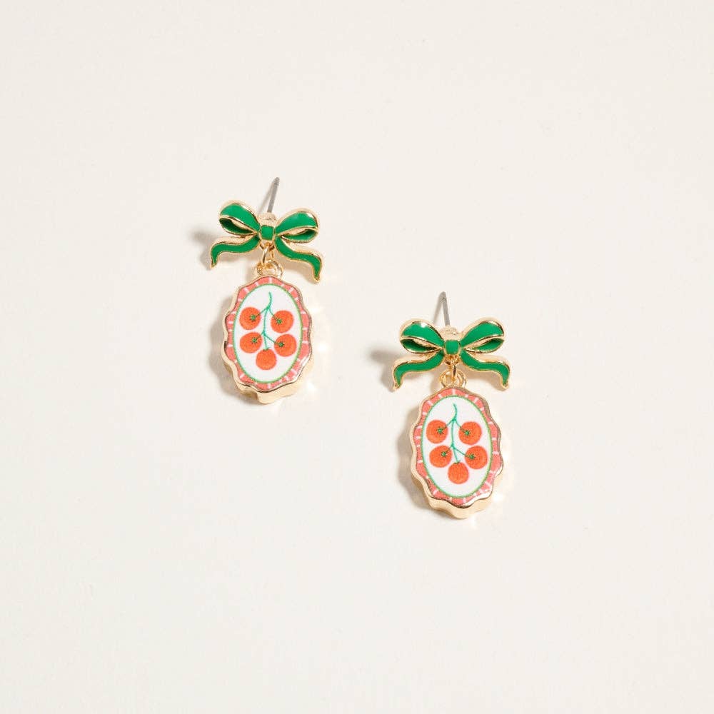 Gold-tone drop earrings with green enamel bow and oval fruit print tile pendant