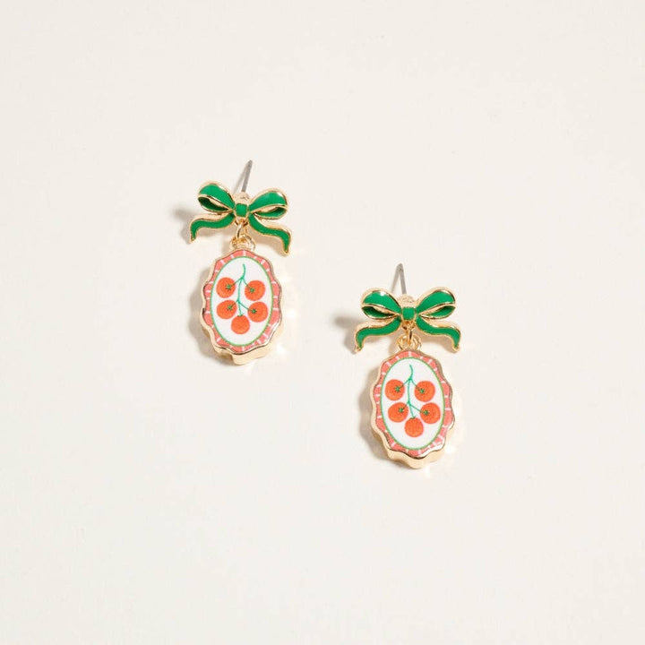 Gold-tone drop earrings with green enamel bow and oval fruit print tile pendant