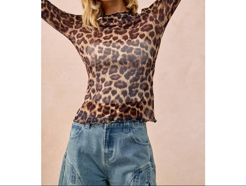 Blonde woman wearing mesh leopard print long sleeve top with blue jeans