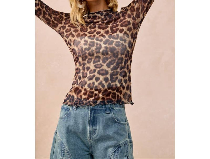 Blonde woman wearing mesh leopard print long sleeve top with blue jeans