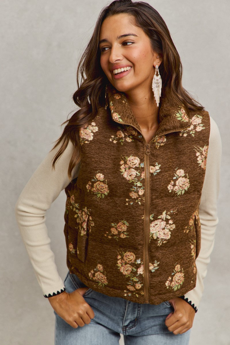 Brown quilted vest with pink floral jacquard pattern worn by smiling woman