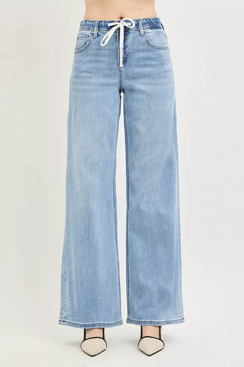 Light blue wide leg denim jeans with white drawstring waist on model