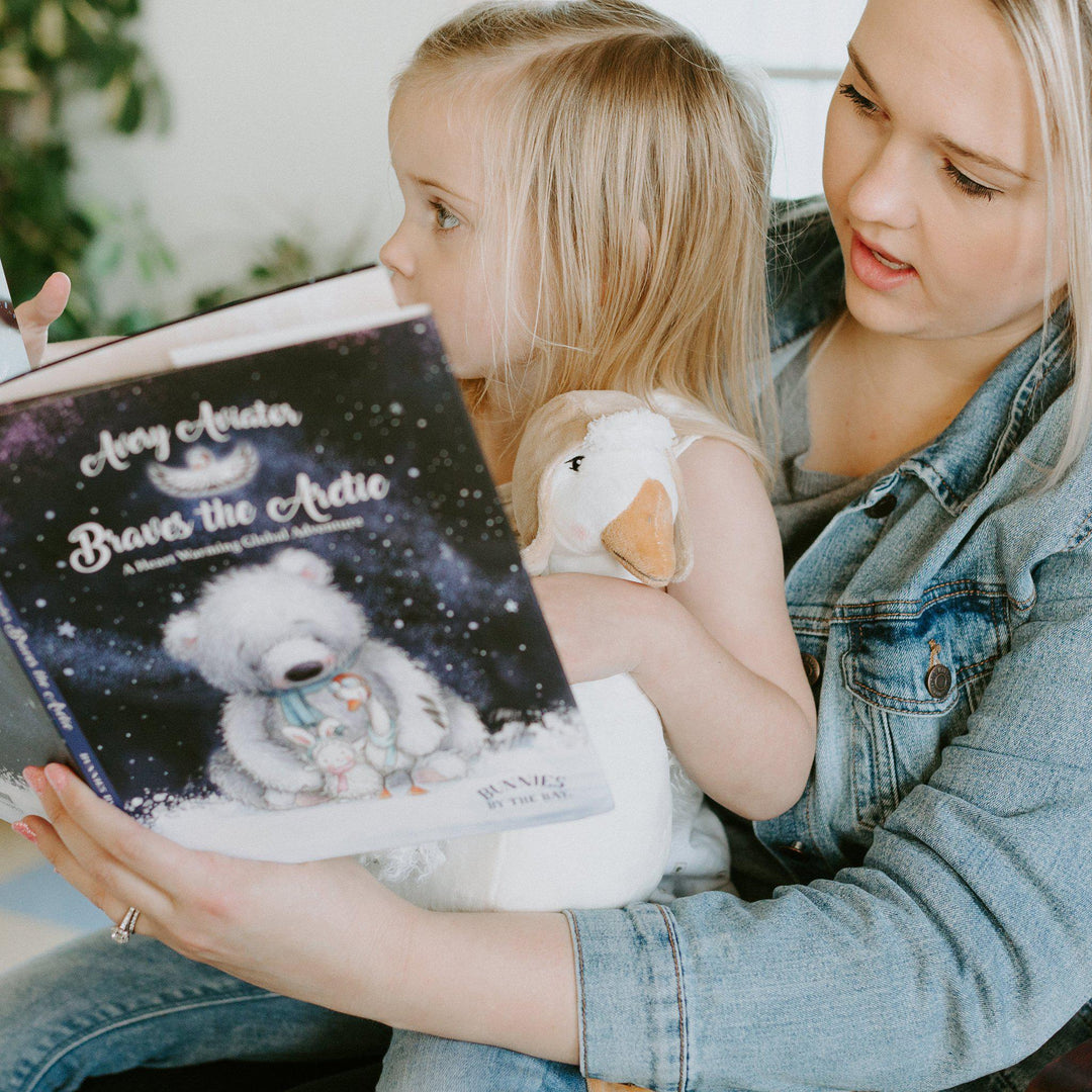 Bunnies by the Bay 'Avery the Aviator Braves the Arctic' storybook held by mother and child