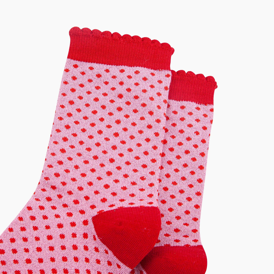 Pink cotton ankle socks with red polka dots, scalloped cuff, and red heel detail