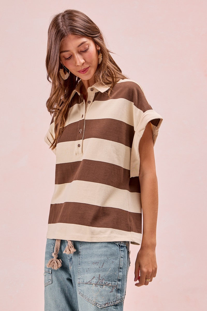 Woman wearing brown and cream striped short-sleeve polo top with button collar