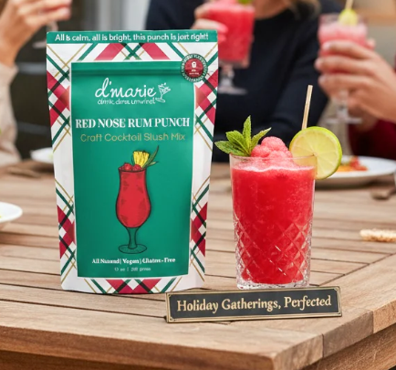 D'Marie Red Nose Rum Punch cocktail mix package with prepared red drink garnished with lime