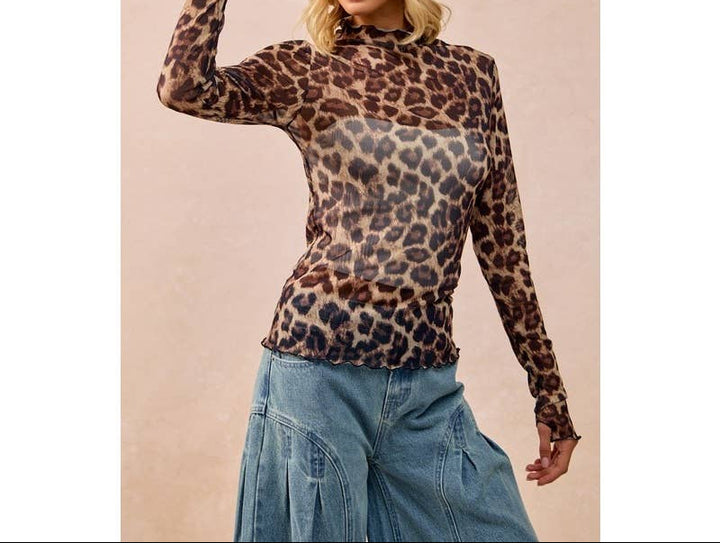Woman wearing leopard print mesh long-sleeve top with cowboy hat and denim skirt