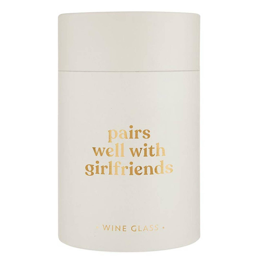 Frosted white stemless wine glass with gold text saying pairs well with girlfriends