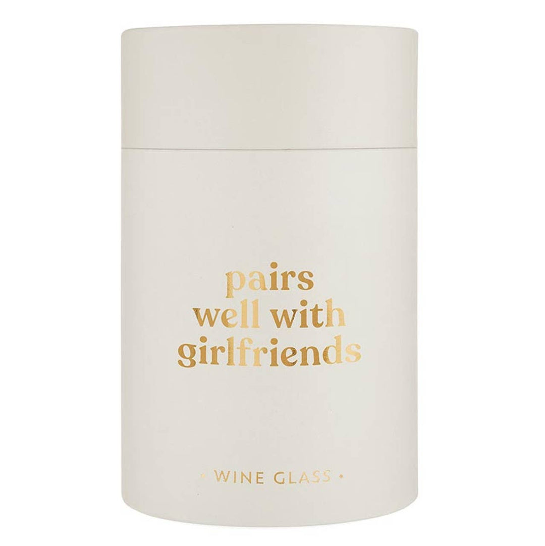 Frosted white stemless wine glass with gold text saying pairs well with girlfriends