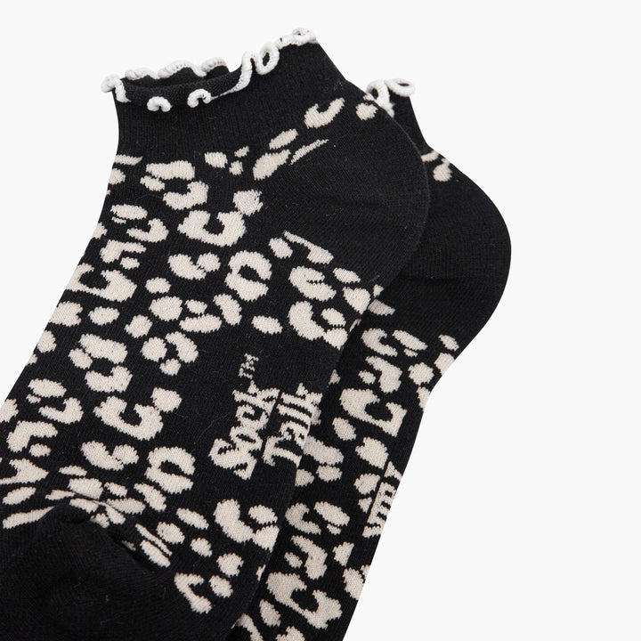 Black leopard print ankle socks with white frilled cuff trim by Sock Talk