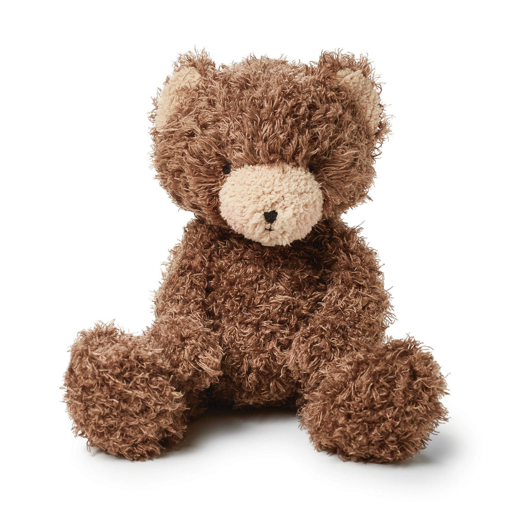 Brown fuzzy teddy bear plush toy with cream snout sitting upright