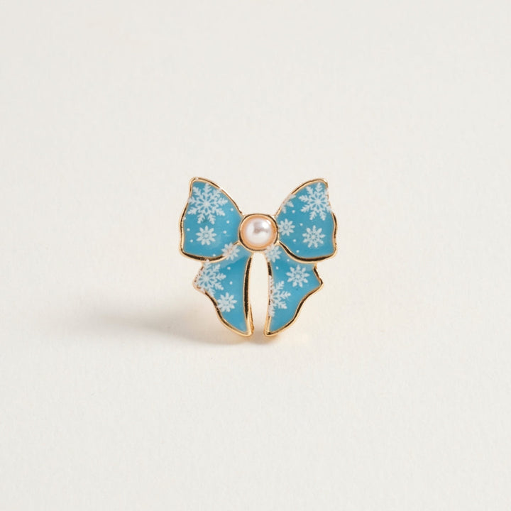 Blue snowflake enamel bow-shaped earring with pearl center and gold trim