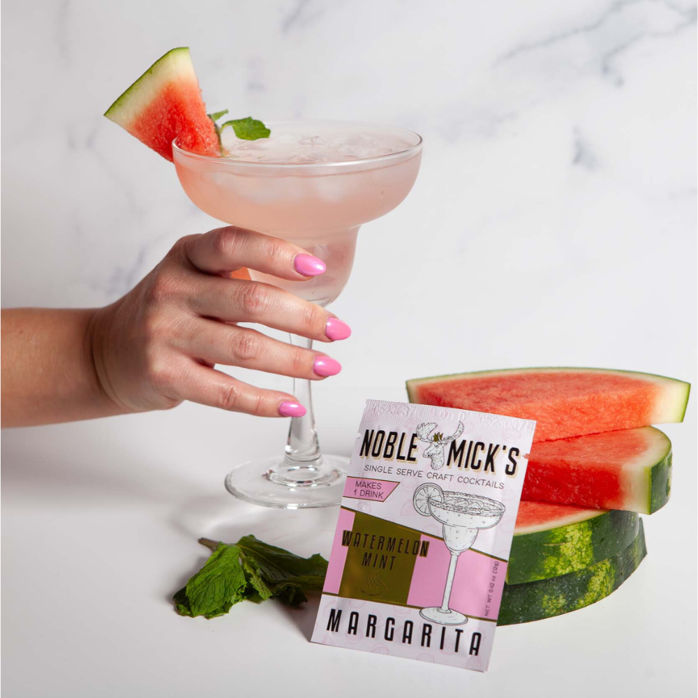 Noble Mick's Watermelon Mint Margarita single serve craft cocktail packet with pink drink and fresh watermelon