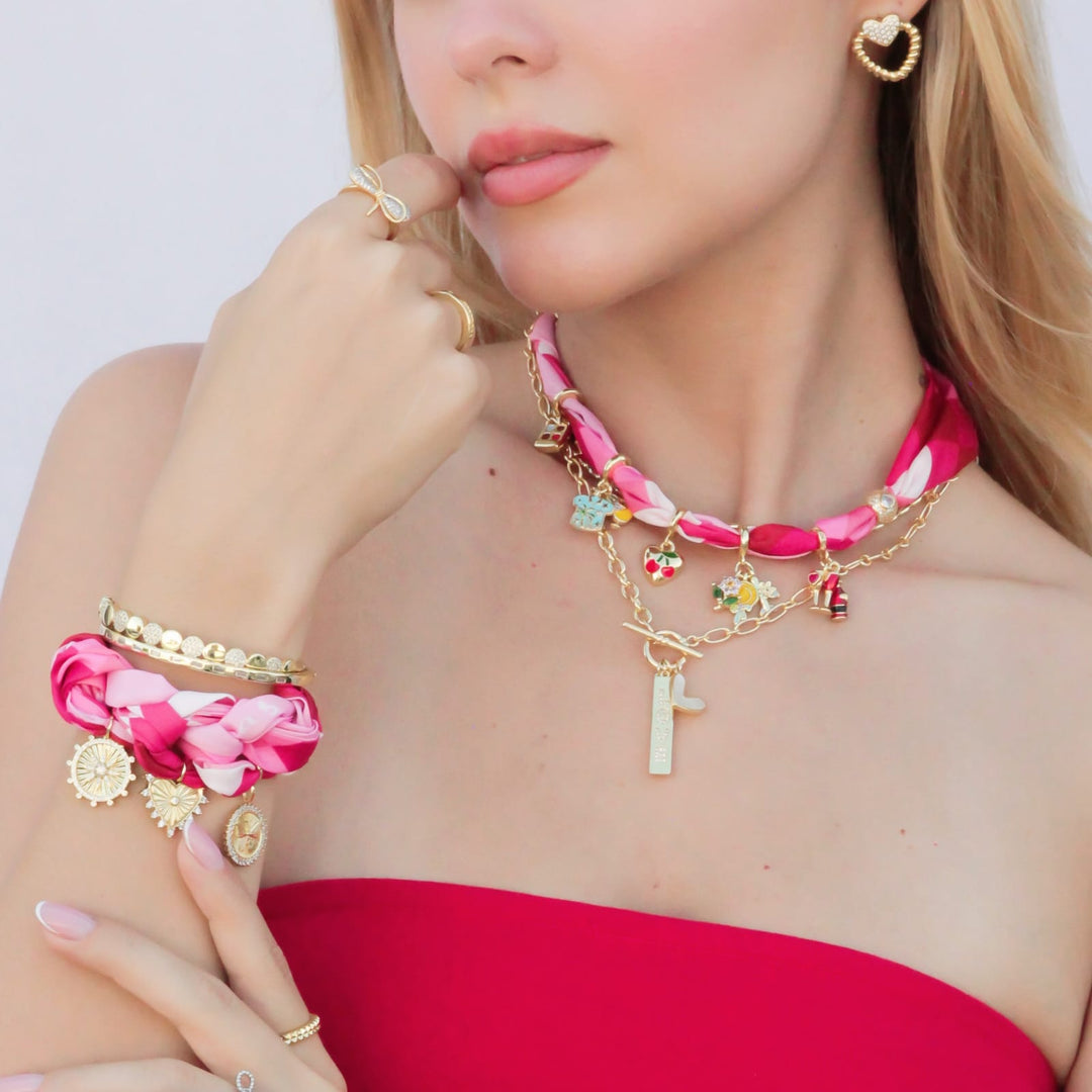 OMG Blings charm necklace with colorful enamel charms and gold chain layered styling