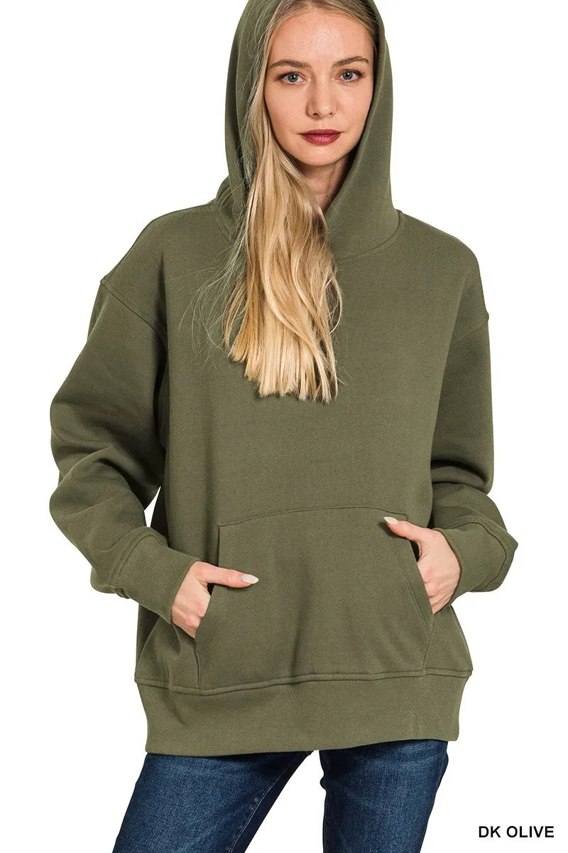 Woman wearing dark olive green fleece hoodie with kangaroo pocket and hood up