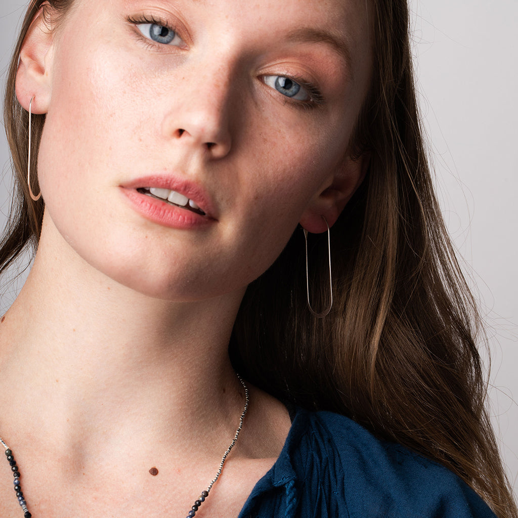 Scout Refined Earring Collection Cosmic Oval Gold Vermeil elongated hoop earrings on model