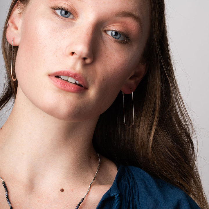 Scout Refined Earring Collection Cosmic Oval Gold Vermeil elongated hoop earrings on model