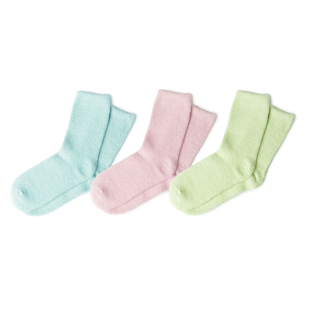 Three pairs of soft fuzzy aloe socks in light blue, pink, and green colors