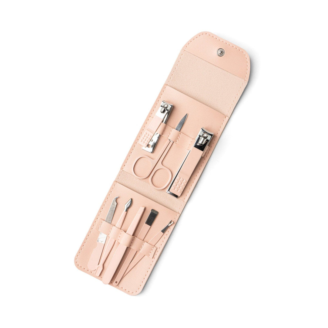 Pink leather nail care kit opened to show manicure tools including clippers, scissors, and files