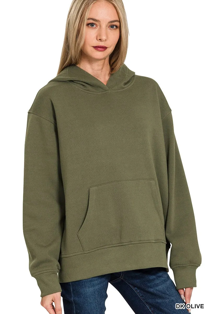 Woman wearing dark olive green fleece hoodie with kangaroo pocket against white background