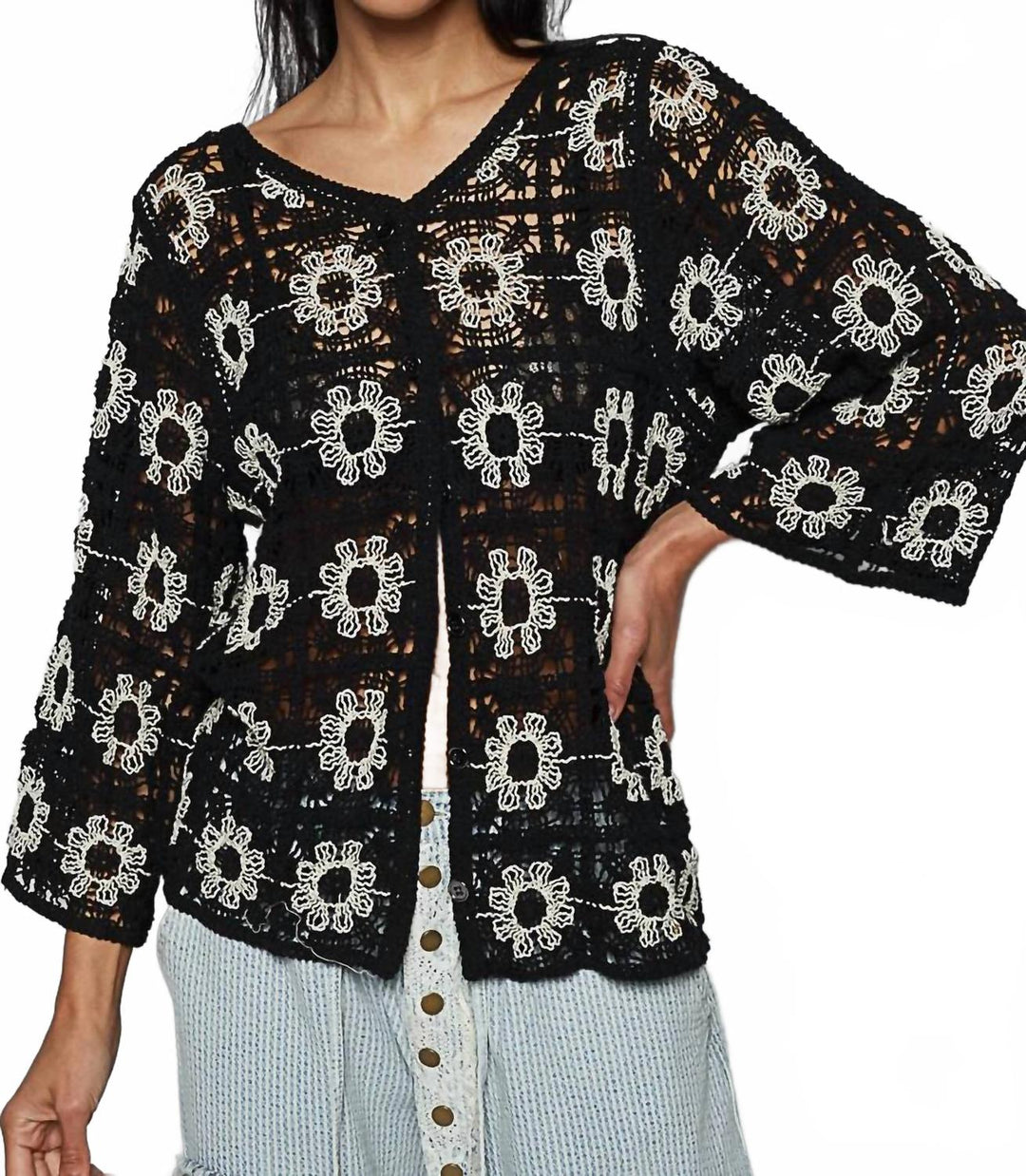 Black crochet cardigan with white floral pattern and open front styling