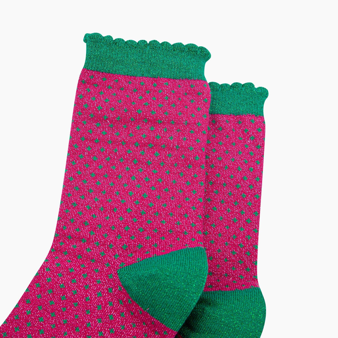 Hot pink glitter crew socks with green polka dots and scalloped green cuff