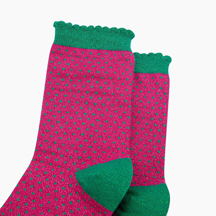 Hot pink glitter crew socks with green polka dots and scalloped green cuff