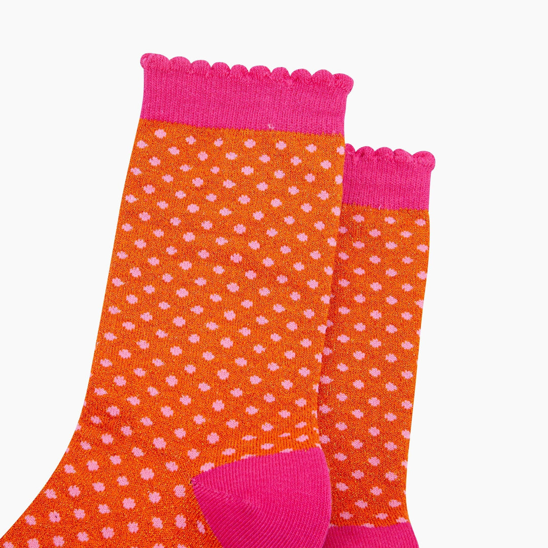 Orange glitter crew socks with pink polka dots and scalloped hot pink cuff