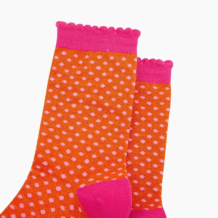 Orange glitter crew socks with pink polka dots and scalloped hot pink cuff