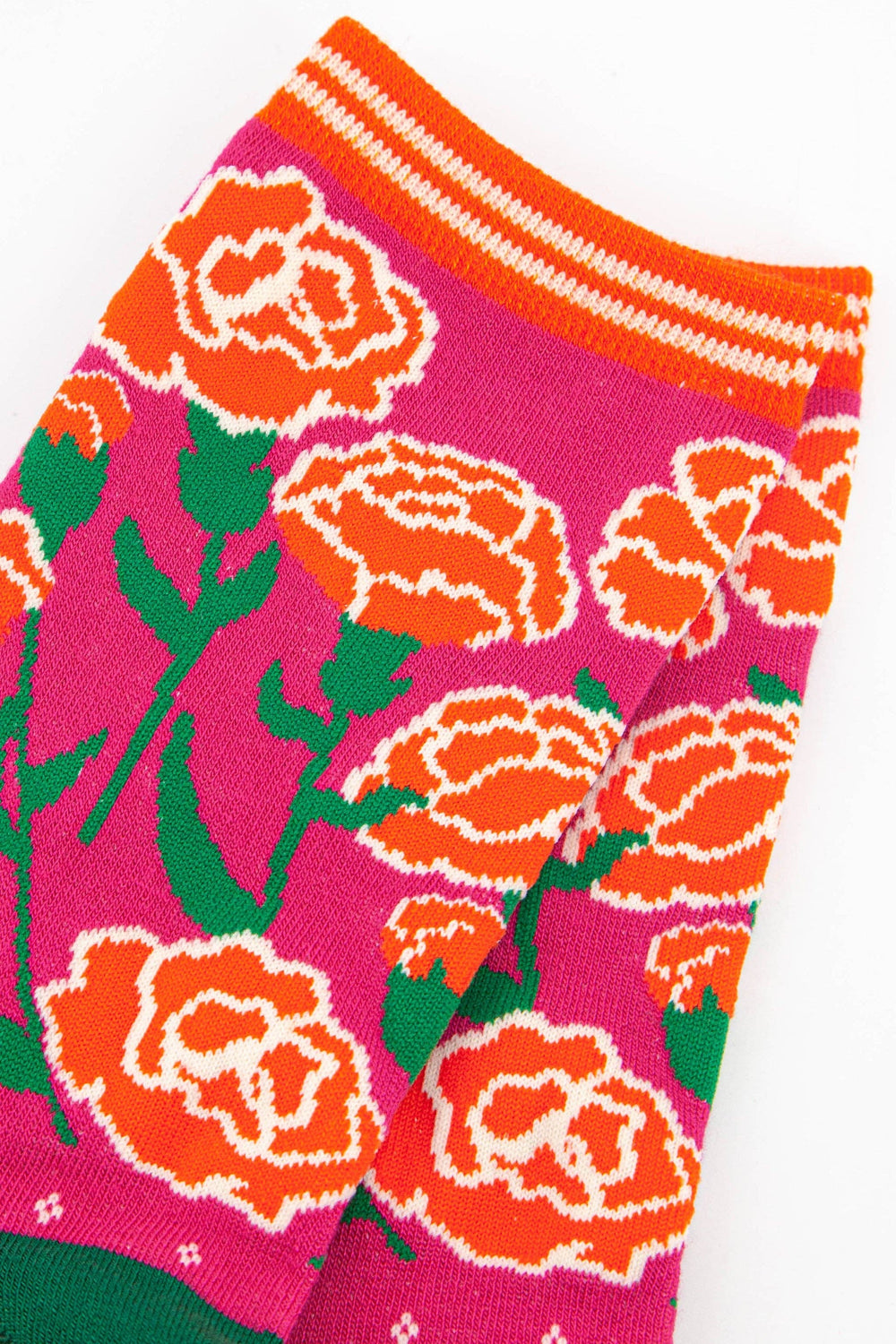 Women's bamboo socks in pink with bold orange carnation floral pattern and striped cuff