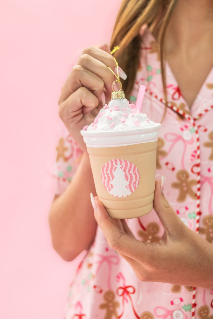 Hand holding a Frappe All the Way coffee drink Christmas ornament with whipped cream topping