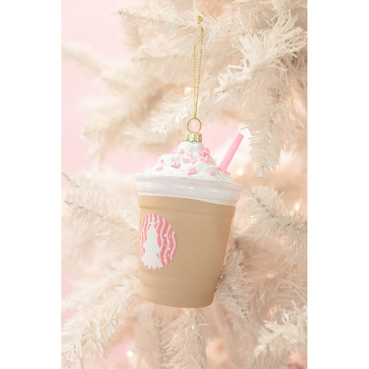 Glass frappe coffee drink Christmas ornament with whipped cream and pink straw hanging on white tree