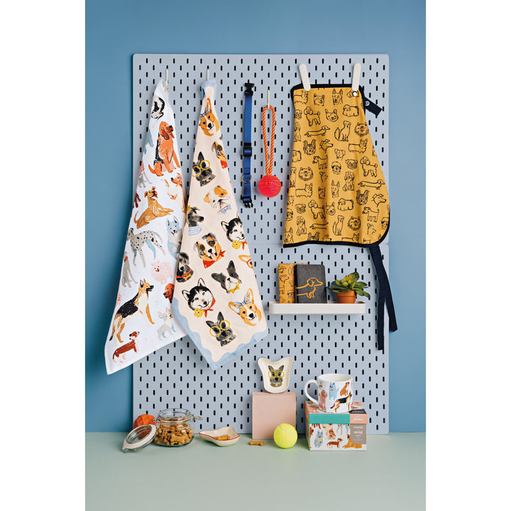 Danica kitchen textiles featuring colorful dog pattern prints including aprons, towels, and accessories