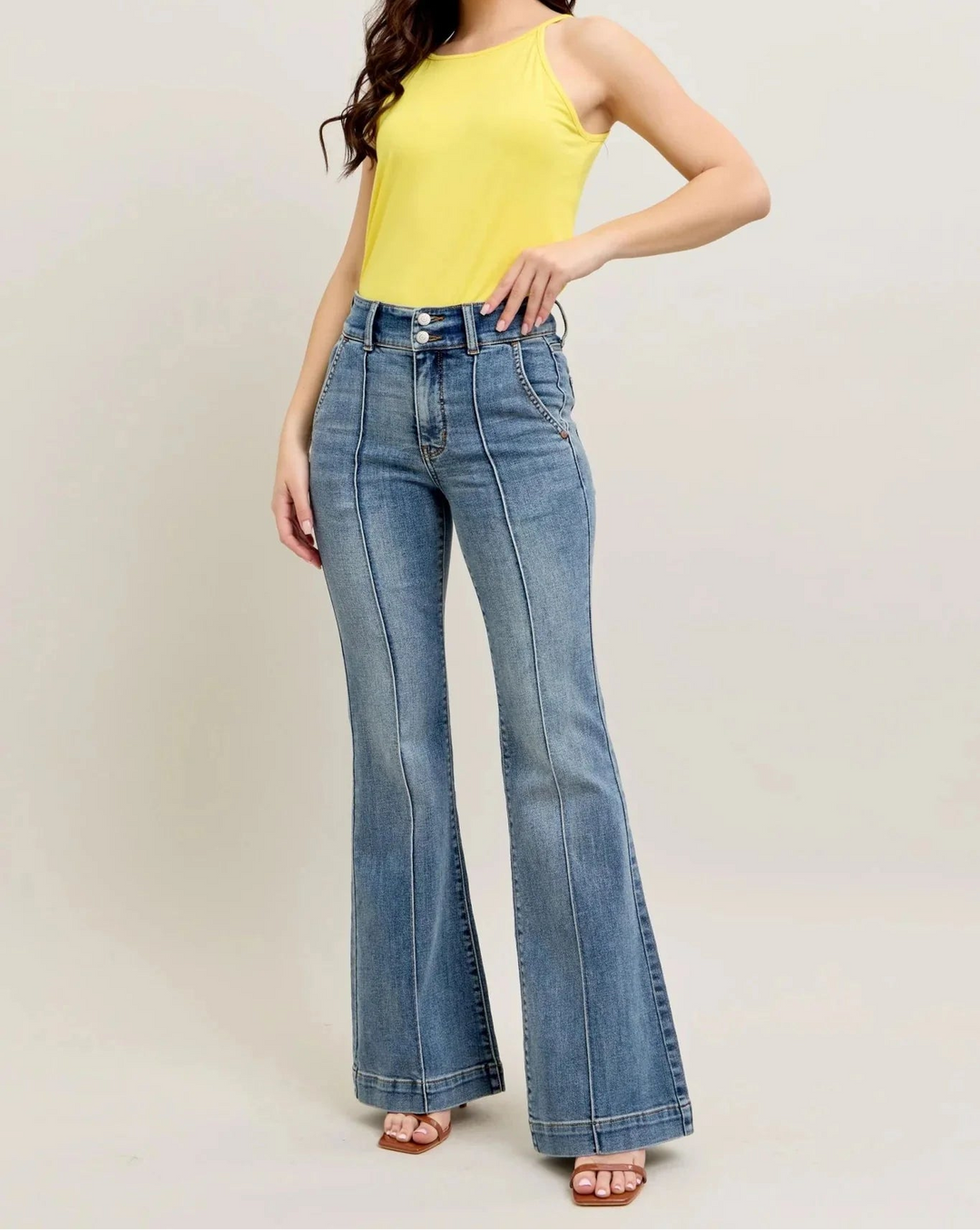 Woman wearing Judy Blue high waisted trouser flare jeans with yellow tank top