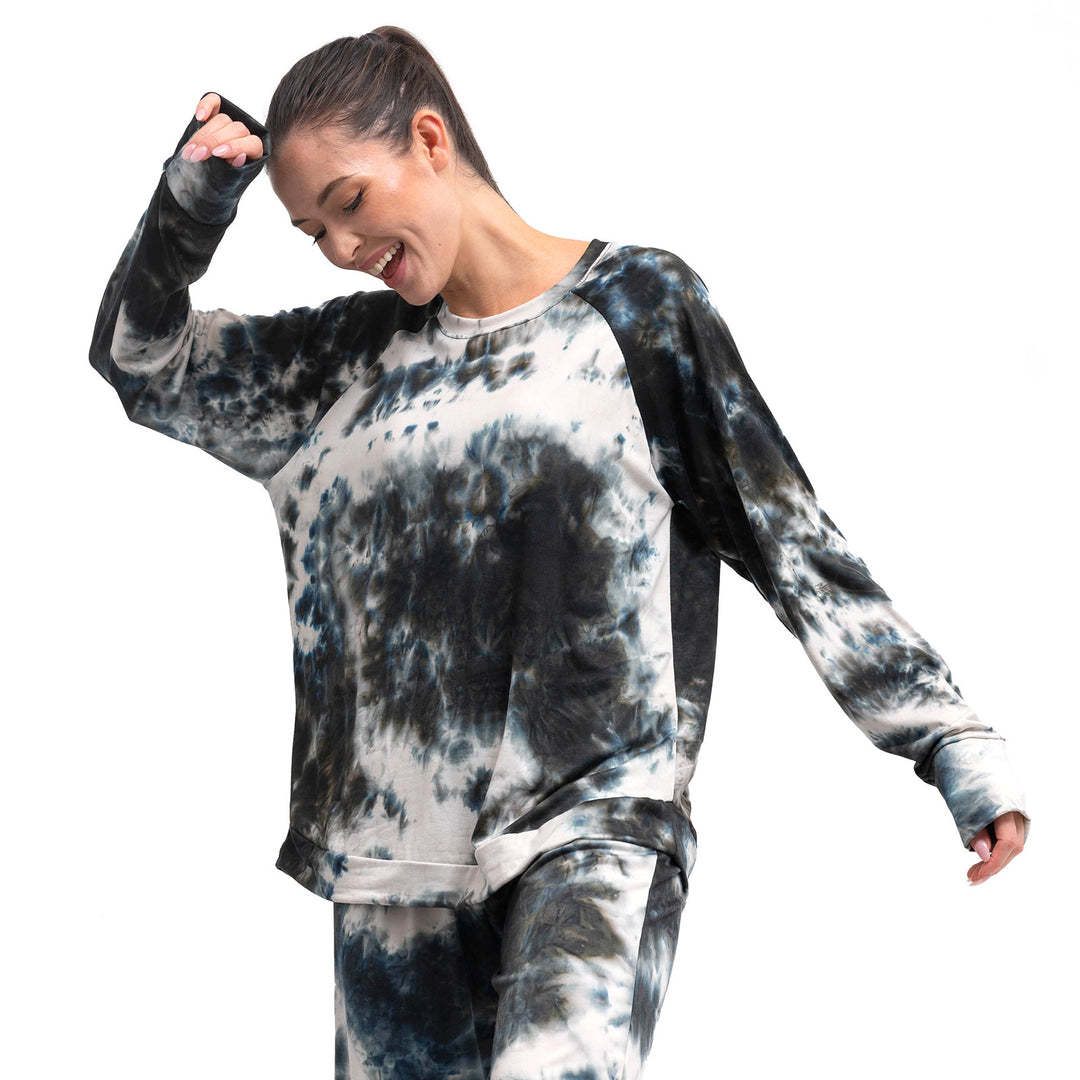 Woman wearing tie-dye sweatshirt with blue gray black white pattern