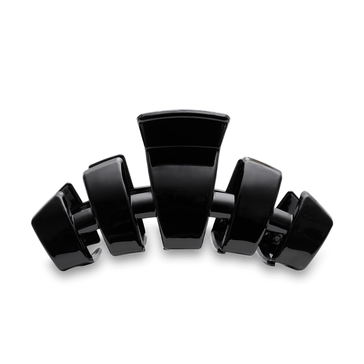 Teleties large black claw clip hair accessory with multiple interlocking teeth on teal background