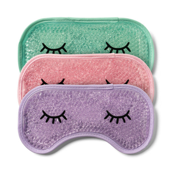 Three glittery gel eye masks with closed eye designs in mint, pink, and purple