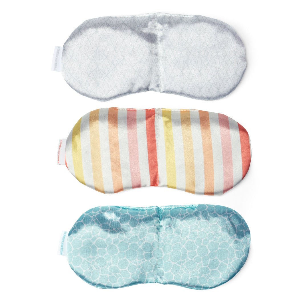 Three weighted eye masks with different patterns on clean white background
