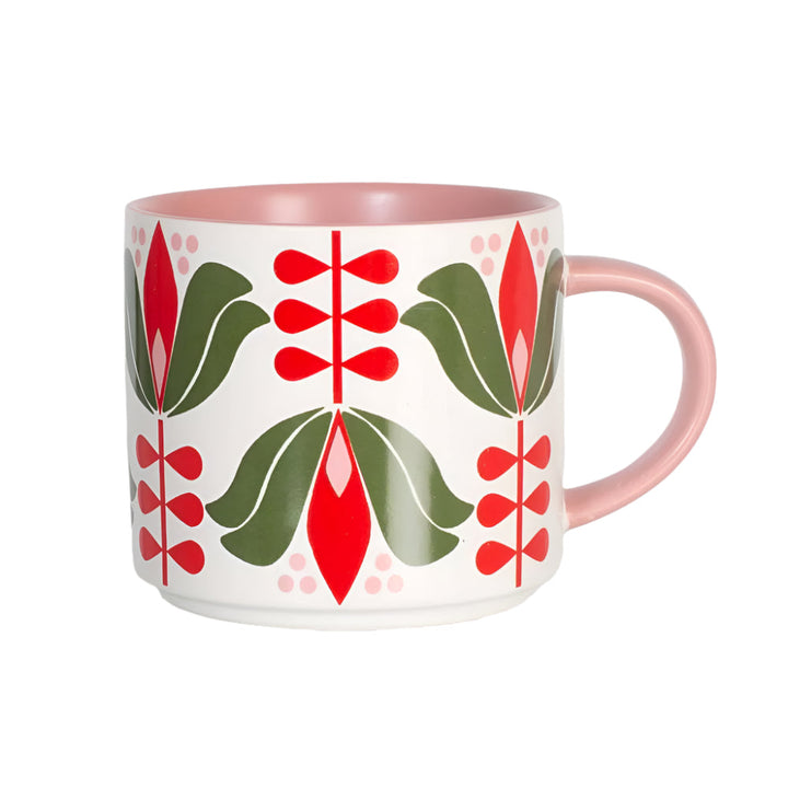 Stackable matte coffee mug with red and green folk art floral pattern and pink handle