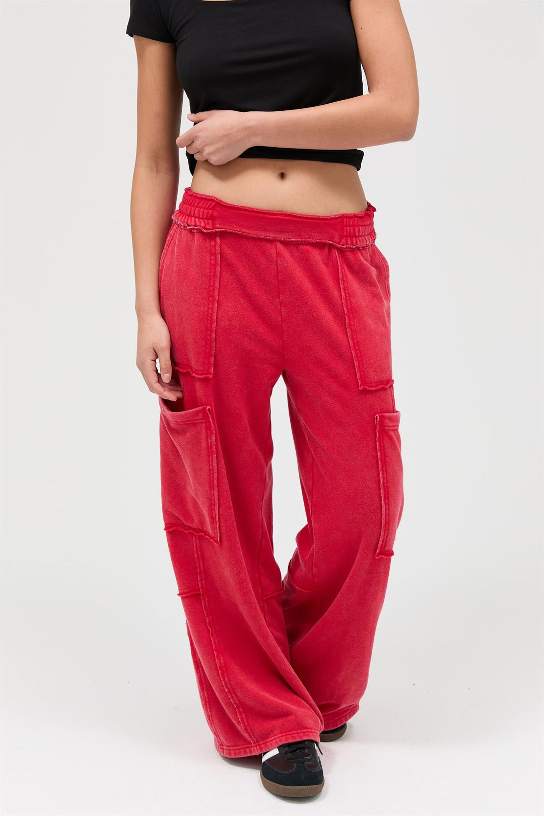 Woman wearing red mineral wash wide leg cargo pants with black crop top