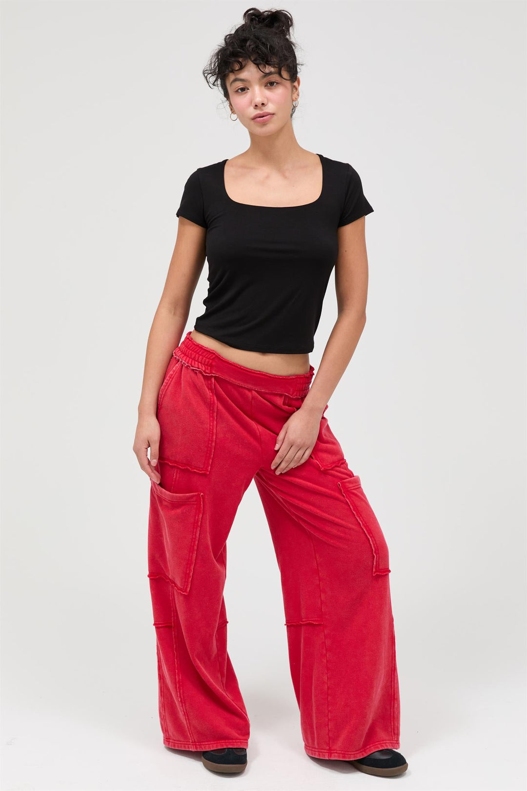Woman wearing red mineral wash wide leg cargo pants with black top