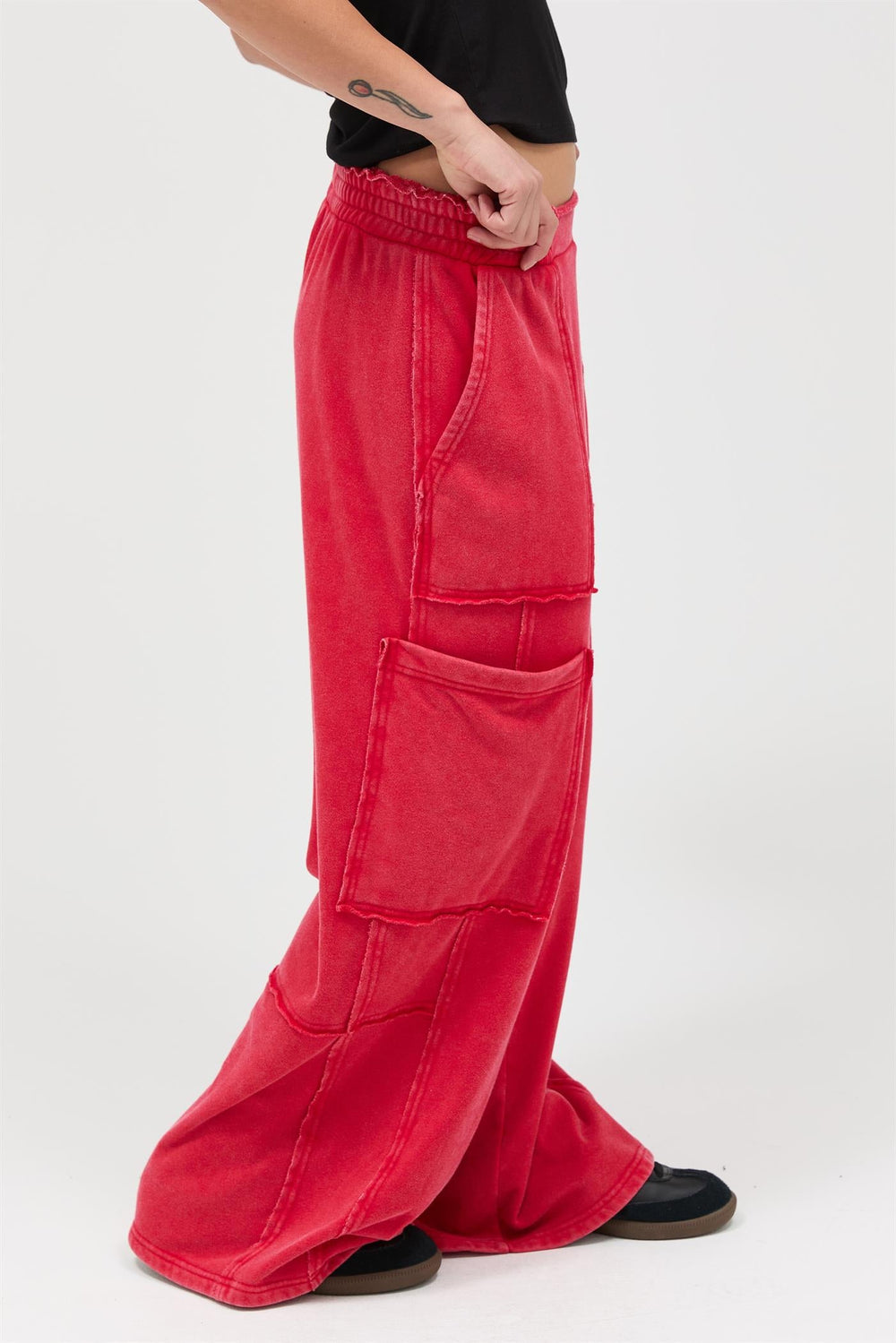 Red mineral wash wide leg cargo pants with multiple pockets and elastic waistband