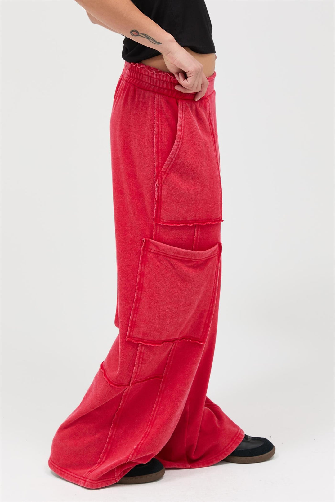 Red mineral wash wide leg cargo pants with multiple pockets and elastic waistband