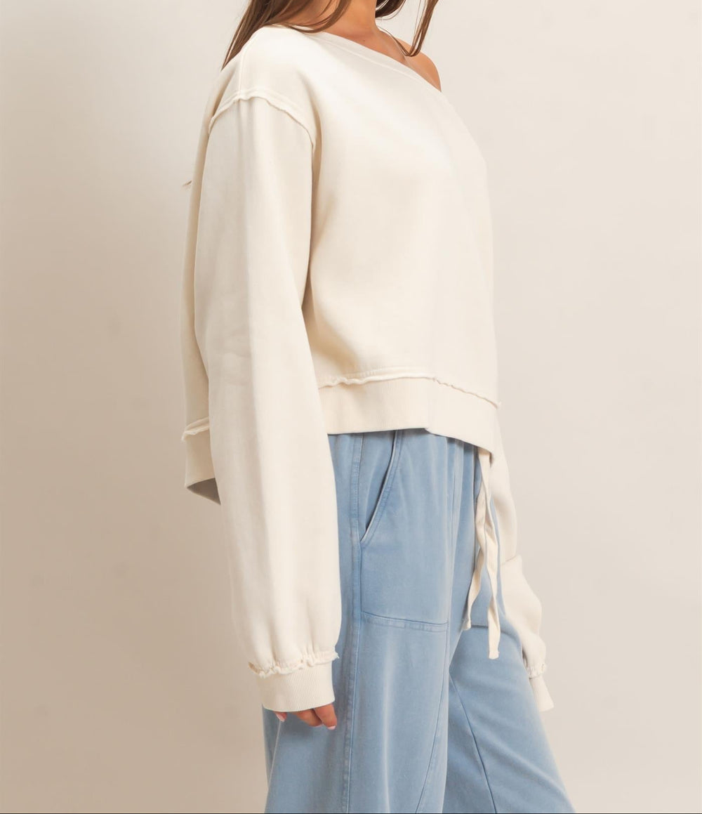 HYFVE raw edge off the shoulder sweatshirt in alpaca cream, paired with light blue joggers