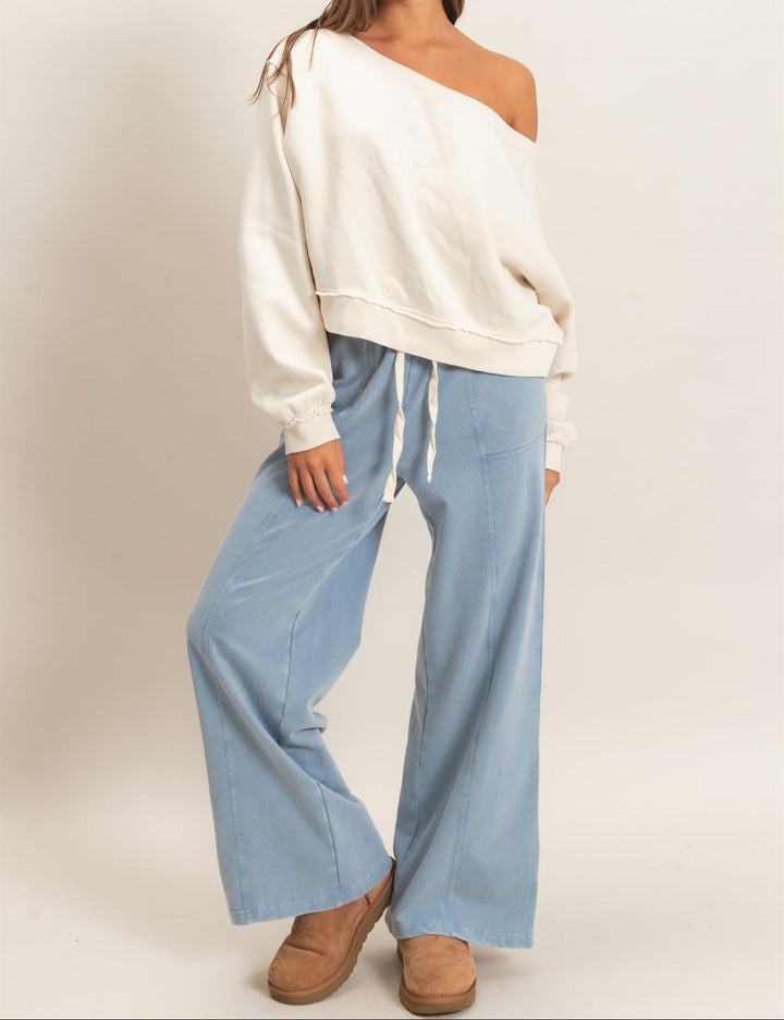HYFVE Raw Edge Off the Shoulder Sweatshirt in cream alpaca color, worn by model