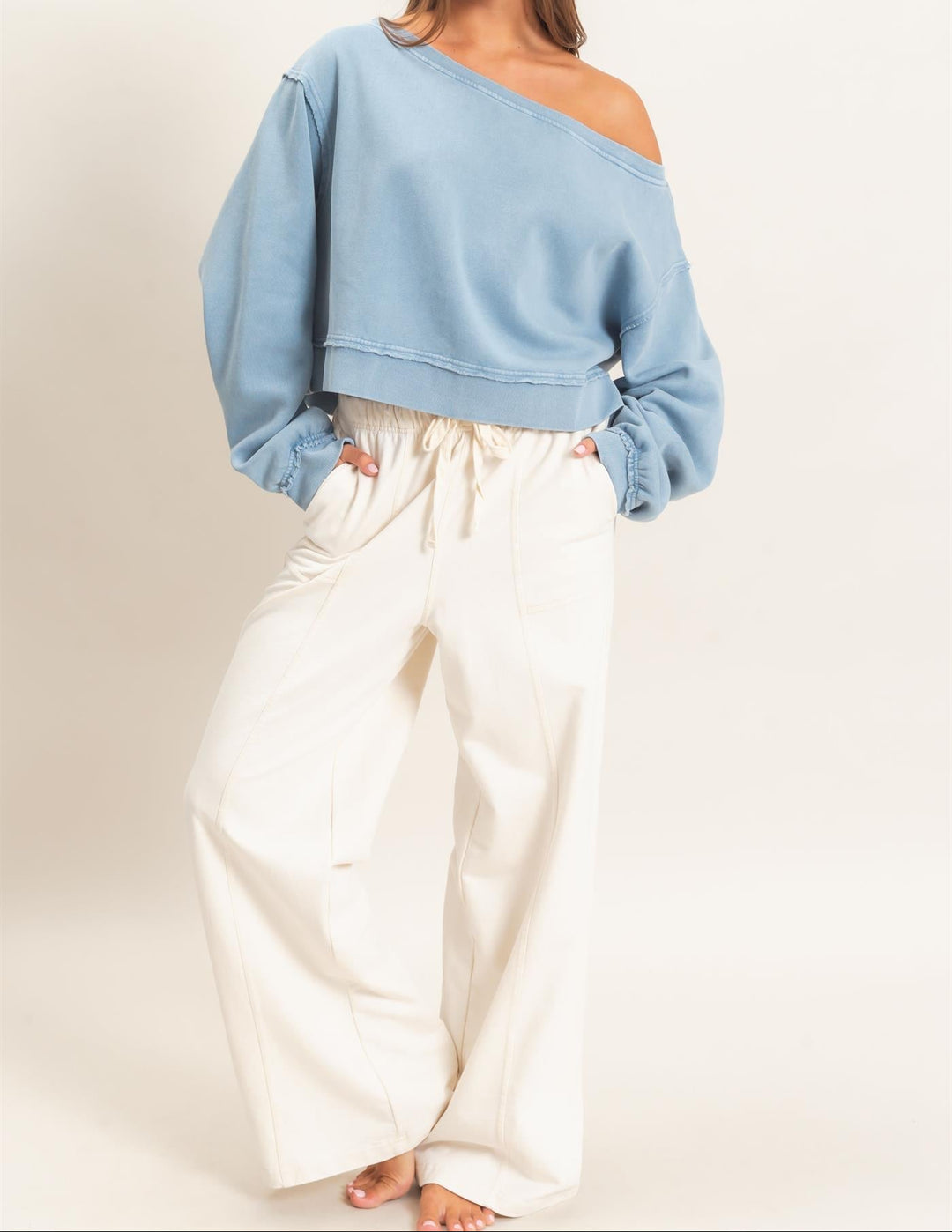 HYFVE raw edge off the shoulder cropped sweatshirt in dusty blue on female model